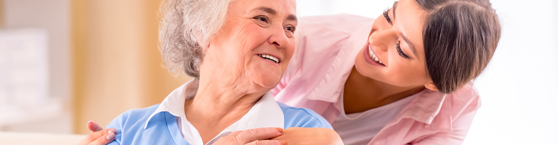 lady behind elder lady smiling